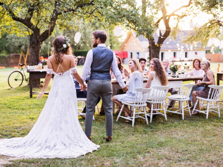 bride and groom in a backyard wedding setup