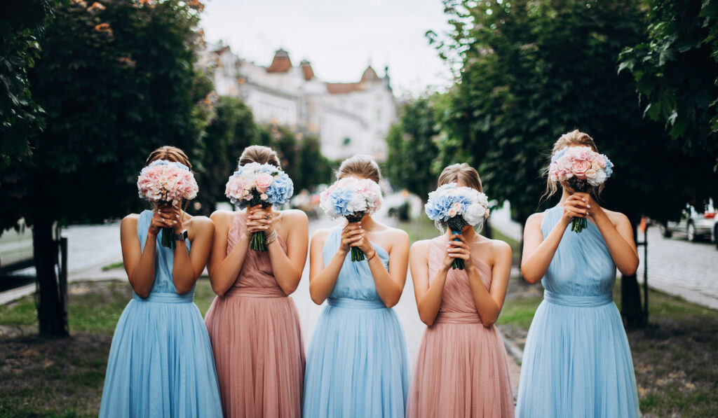 bridesmaids wearing pastel colored dresses
