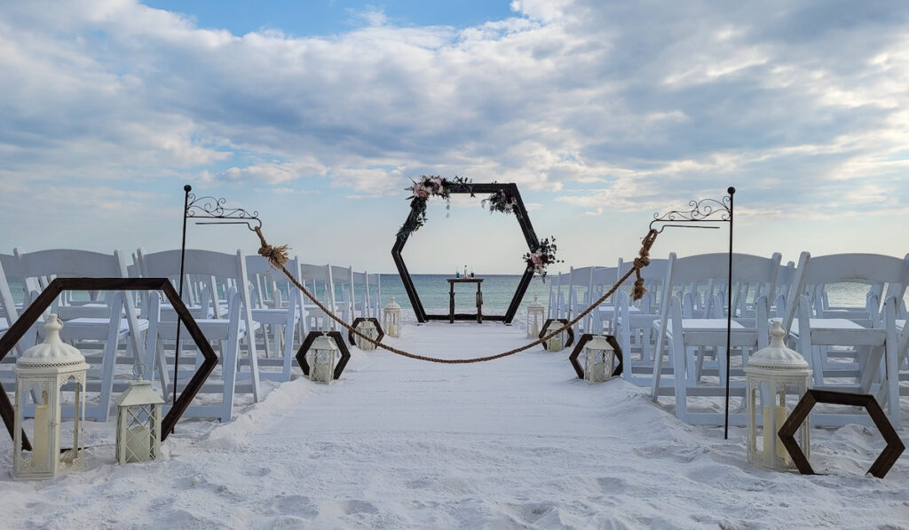 A wedding chapel is set up for a sunset wedding on the beach