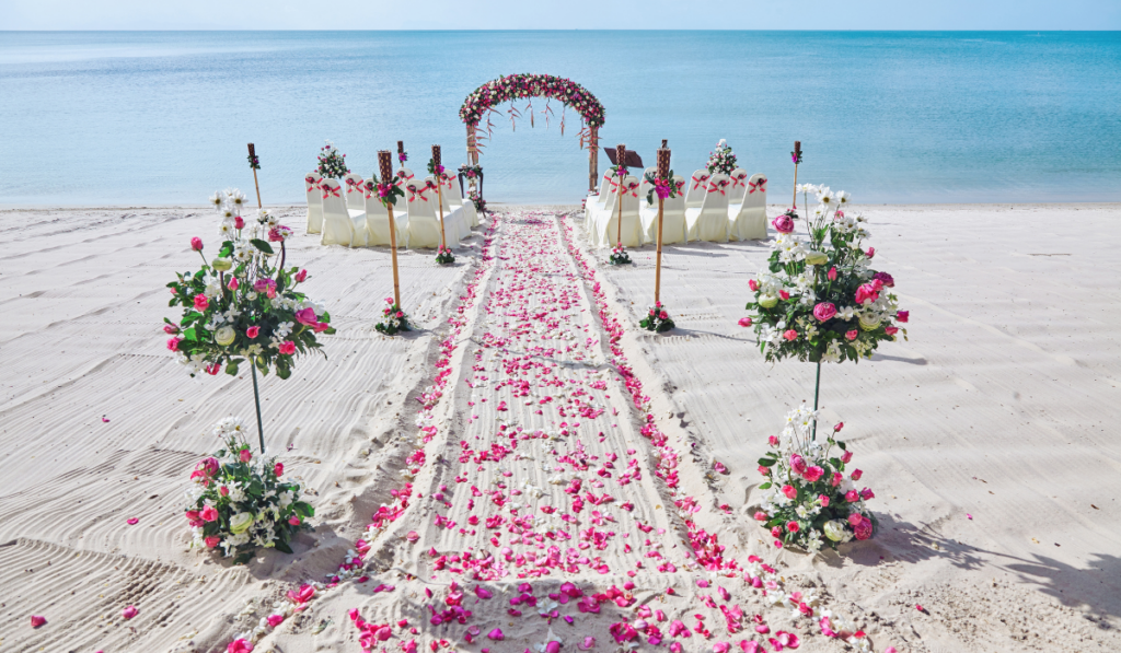 white sand beach wedding with flower petals
