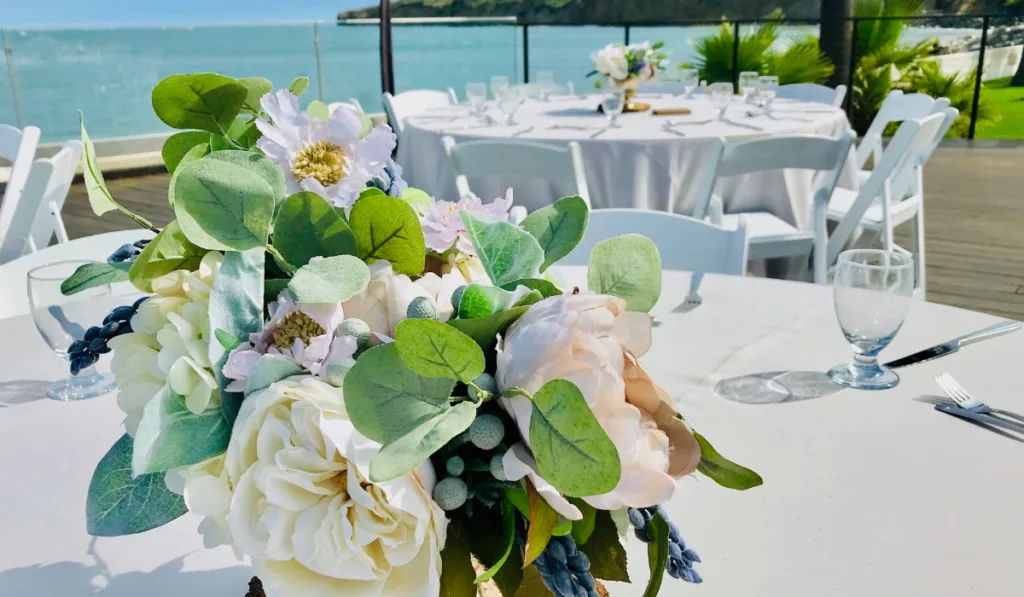 Beautifully decorated tables at an outdoor venue by the ocean in Point Loma