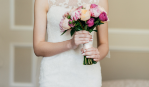 Wedding-bouquet-in-brides-hands.-Slim-bride-in-white-dress-holding-beautiful-diy-flowers-in-hands