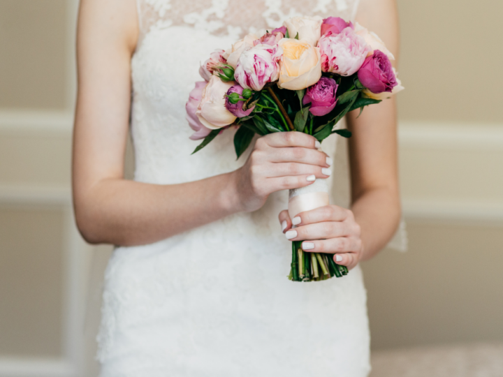 Wedding-bouquet-in-brides-hands.-Slim-bride-in-white-dress-holding-beautiful-diy-flowers-in-hands
