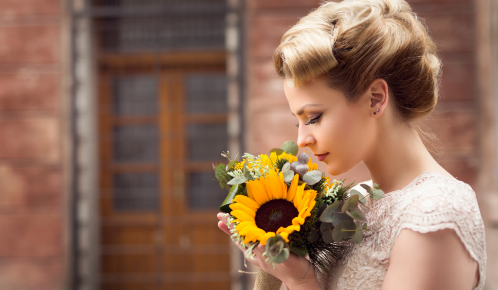bride smelling her DIY sunflower wedding bouquet