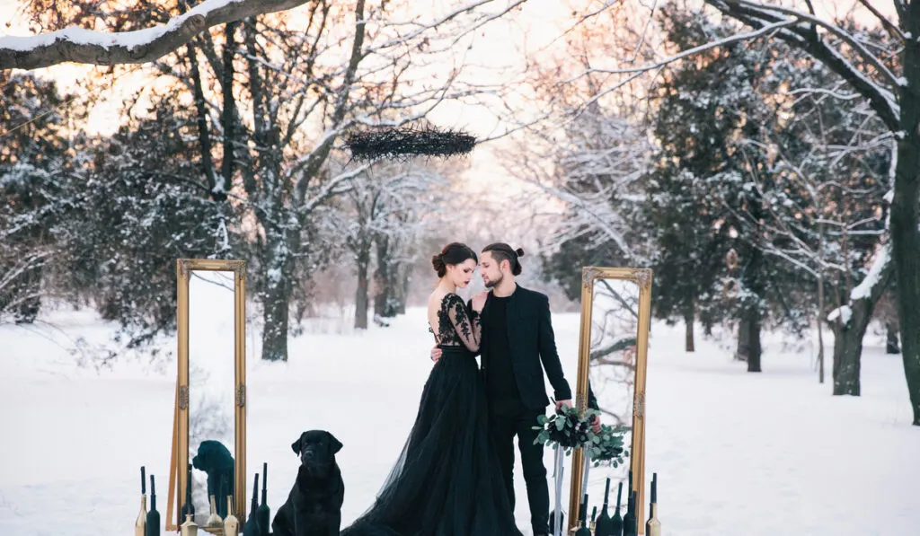 black motif wedding couple in forest during winter 