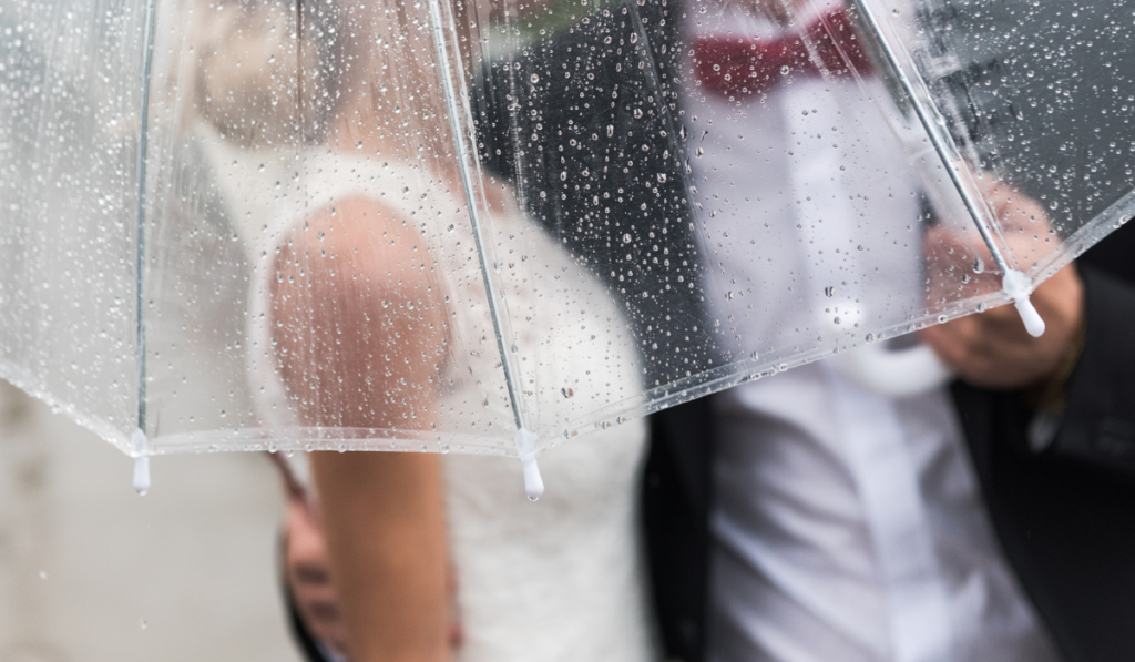 the bride and groom in the rain