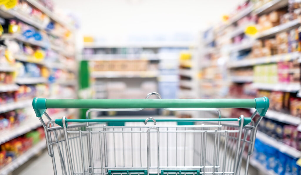 Background and wallpaper of shopping cart in supermarket departmentstore for choosing and buying grocery things at shelf.
