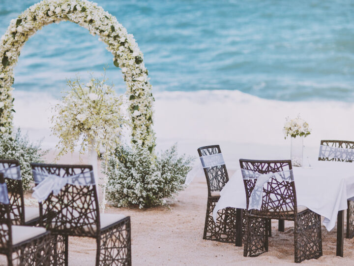 Beach wedding venue setting with flower, floral decoration on arch