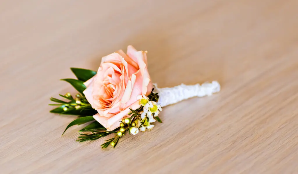Boutonniere on wooden background 