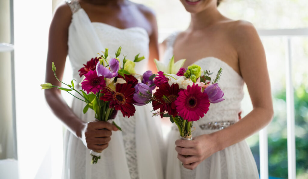 Bride and bridesmaids standing with bouquet

