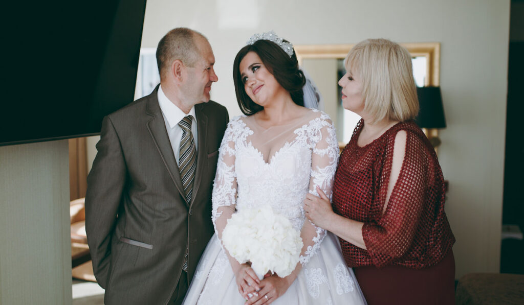Bride and her parents getting emotional before the wedding ceremony 