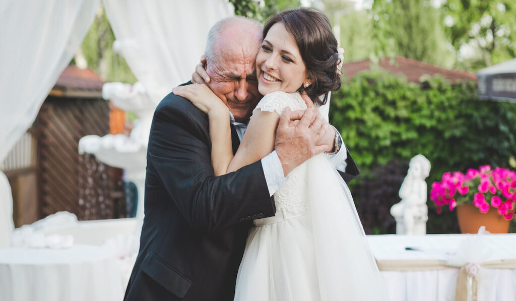 Bride father crying and hugging his daughter on her wedding -