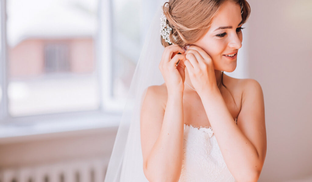 Bride smiling while getting ready for wedding ceremony 