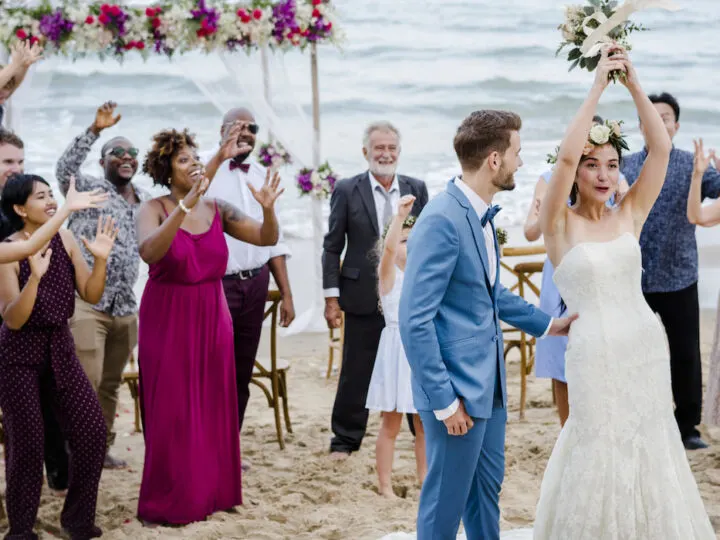 Bride-throwing-the-bouquet-at-wedding-on-the-beach