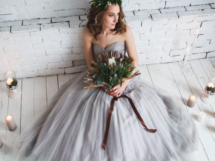 Bride-wearing-gray-wedding-dress-sitting-down-on-the-floor