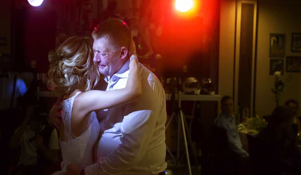 Father crying while dancing with his daughter, the bride 