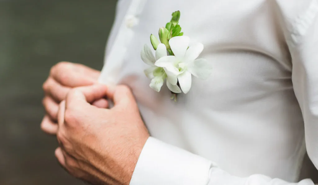 Groom boutonniere white orchids on white shirt -