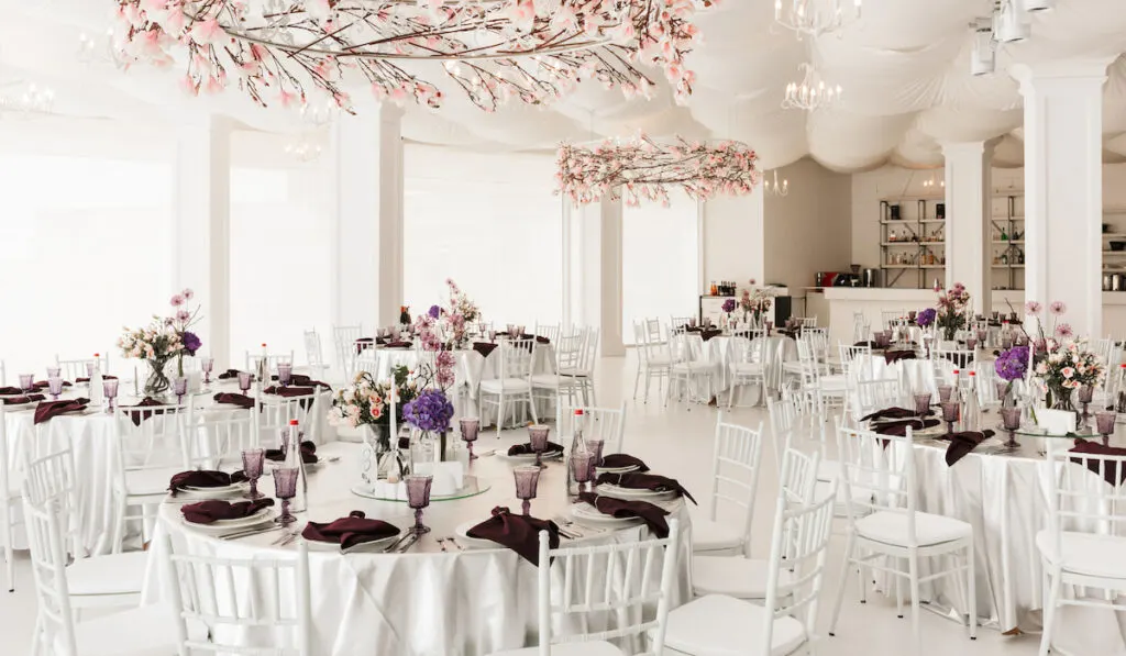 Photo-of-beautiful-white-wedding-hall-with-big-tables