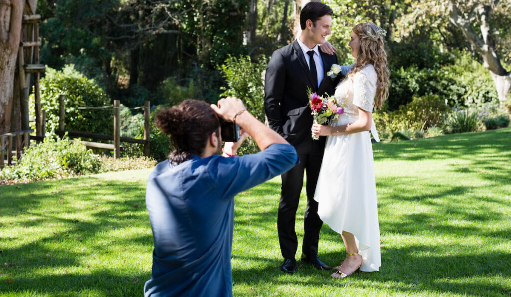 Photographer taking photo of newly married couple
