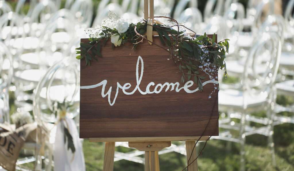 Romantic wedding ceremony on the beach. Sign welcome
