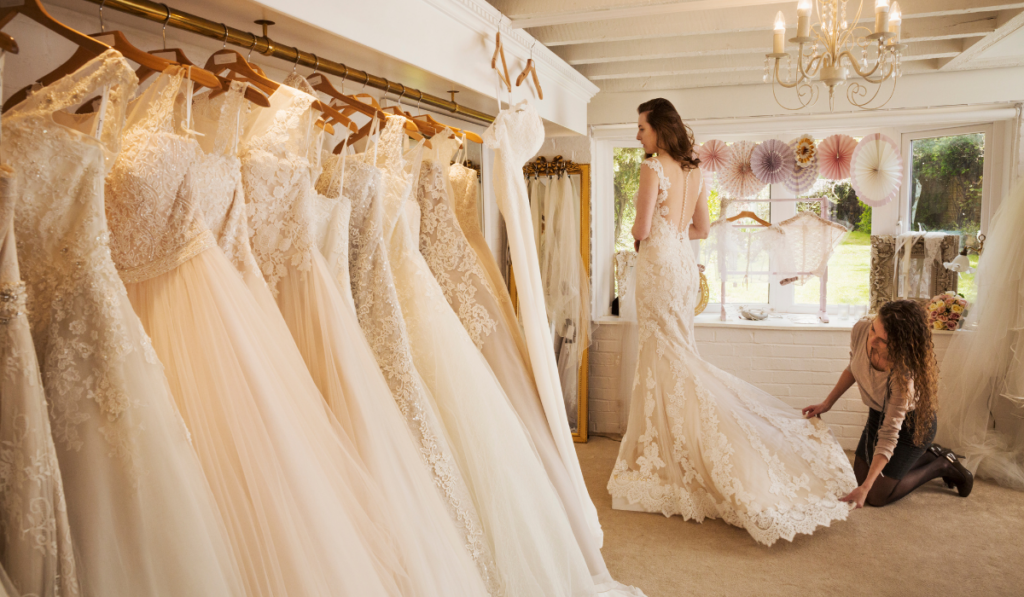 Rows of wedding dresses on display in a specialist wedding dress shop.
