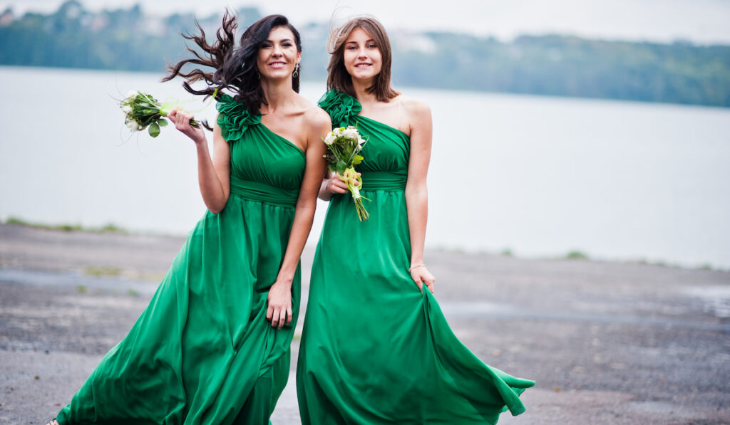 Two charmed girls bridesmaids on green dress
