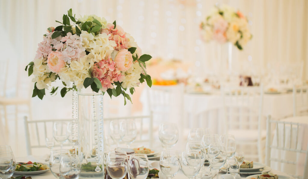 Vases with flowers on the wedding table
