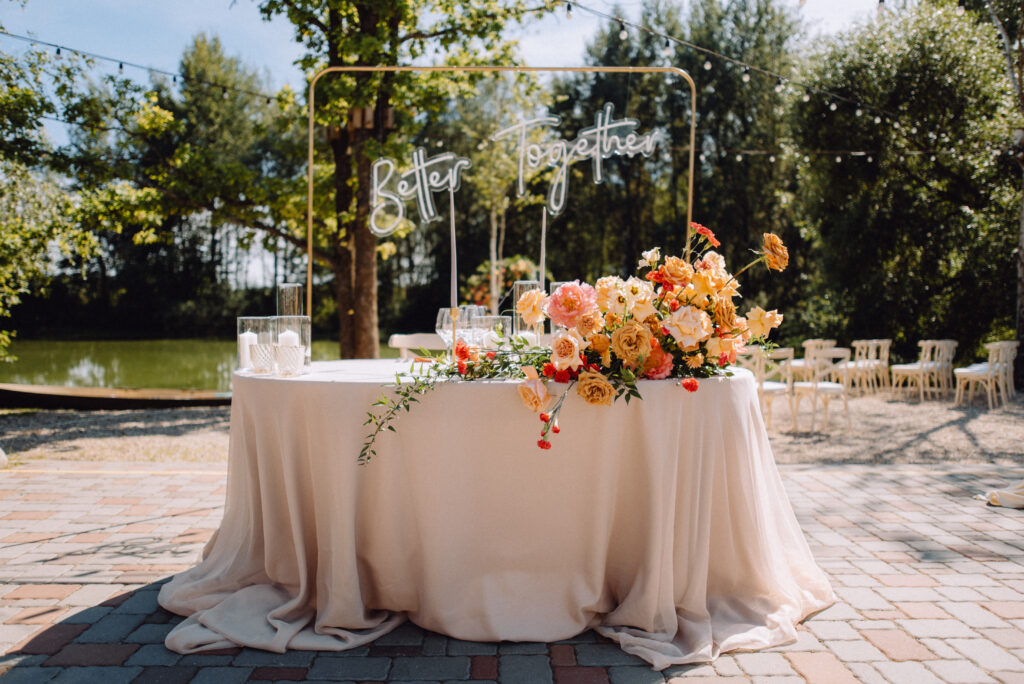 Wedding table with outdoor decorations of fresh flowers
