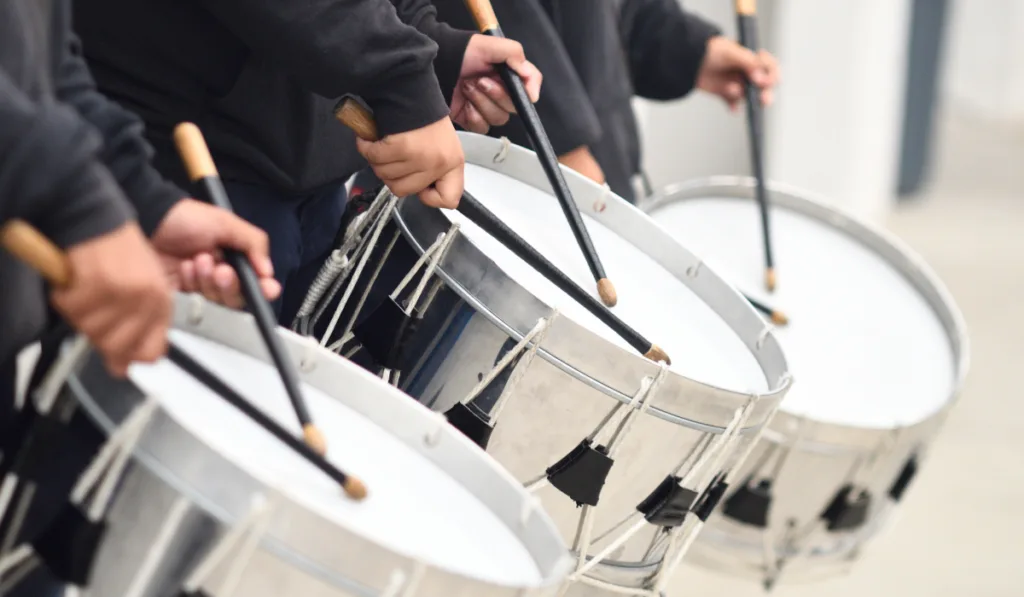band wearing black and loading their silver drums