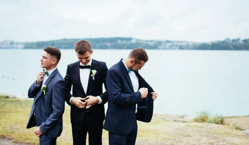 grom and his groomsman fixing their suit stolen shot