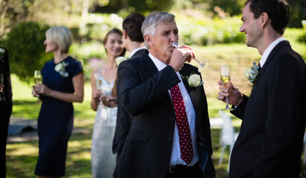 guest having champagne while talking to each other at the wedding venue