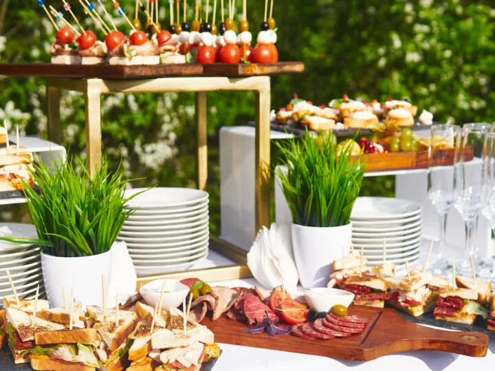 outdoor-buffet-table-with-glasses-and-sandwiches-for-wedding-reception
