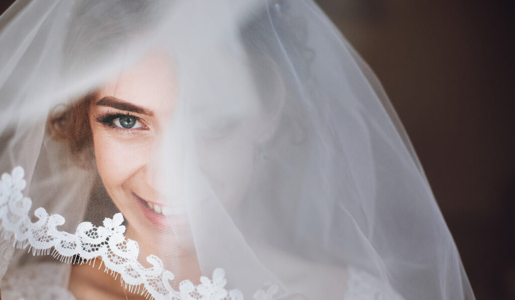 portrait of a beautiful bride under her lace veil
