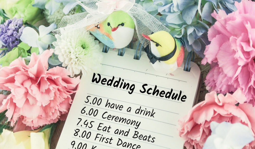 wedding schedule planning on note paper groom bride bird with flowers on background 