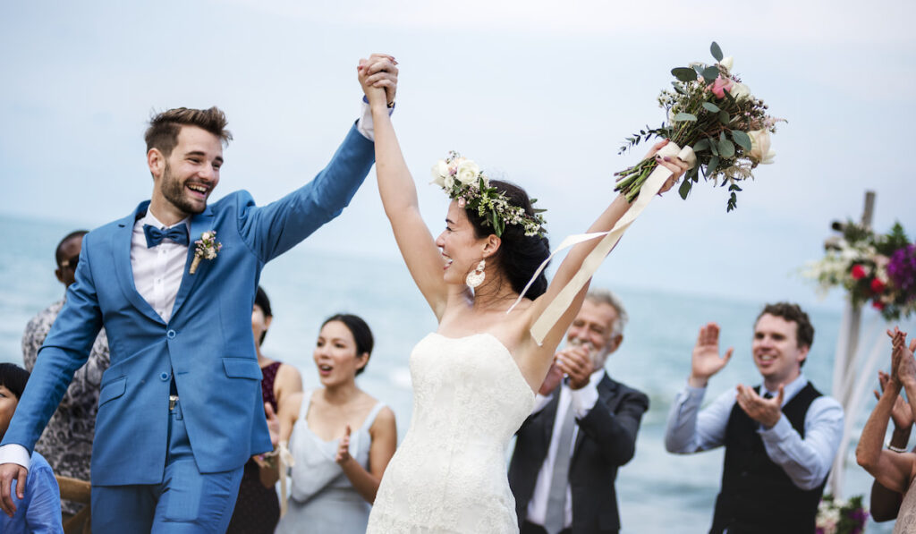 Young couple in a wedding ceremony at the beach
