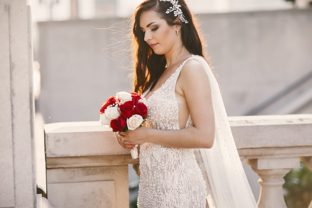 Beautiful bride wearing white wedding dress with bouquet of flowers