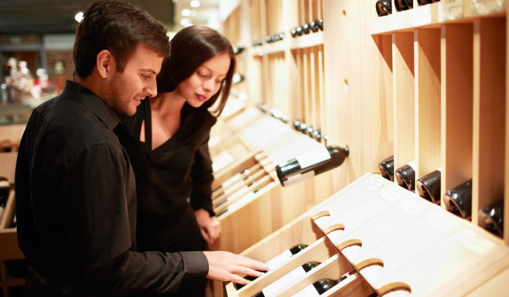 Young couple choosing wine in a store

