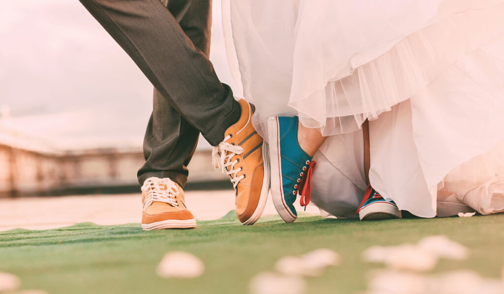 groom and bride low angle photo wearing sneakers