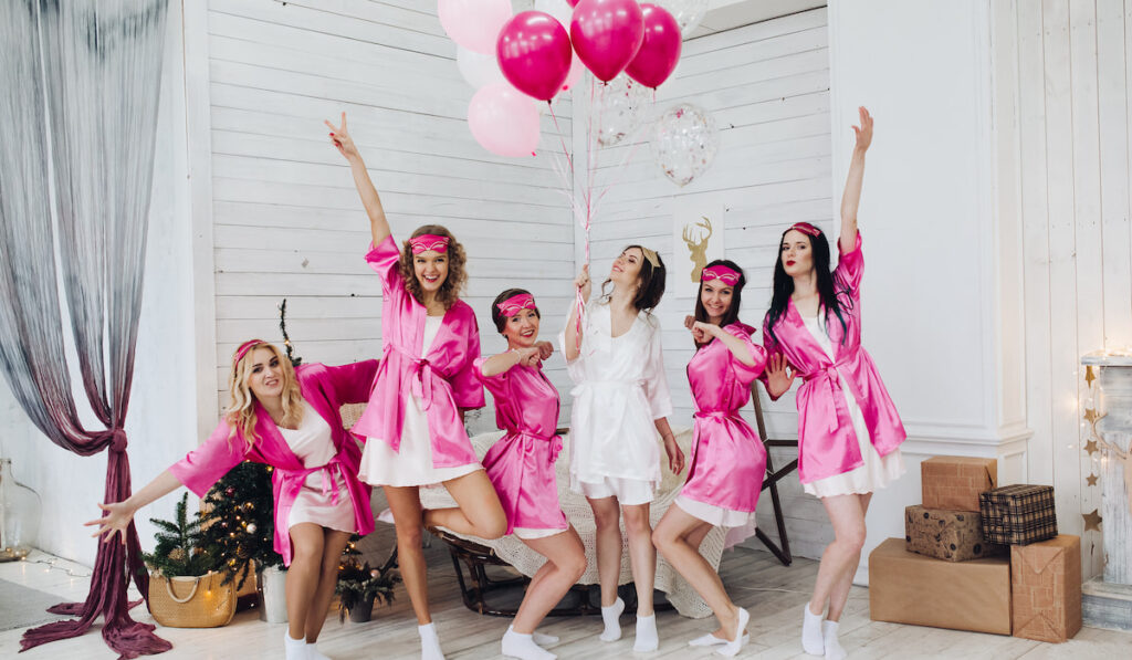 Bridesmaids and bride having fun at bachelorette party
