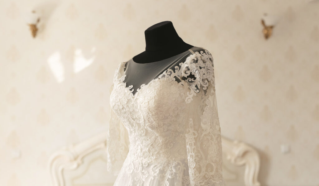 Gorgeous wedding dress on a mannequin in a white room
