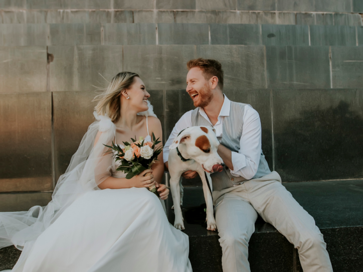 newly wed couple, groom holding a dog