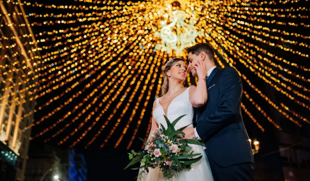 Newly wed couple with lights on the background