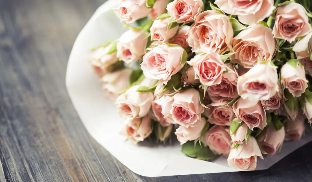 Bouquet of beautiful pink spray roses on the table