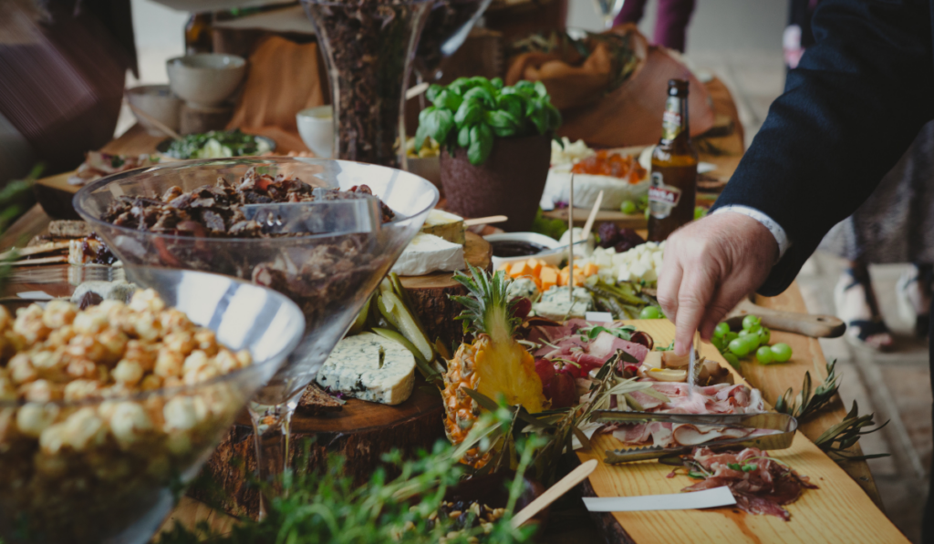 Food spread at wedding, male guest getting some cold cuts
