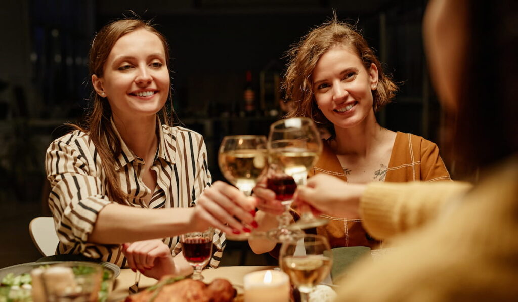Girls toasting with wine at party