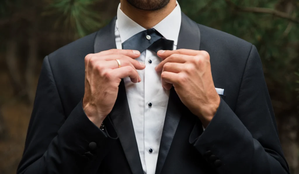 Groom at wedding tuxedo in the forest
