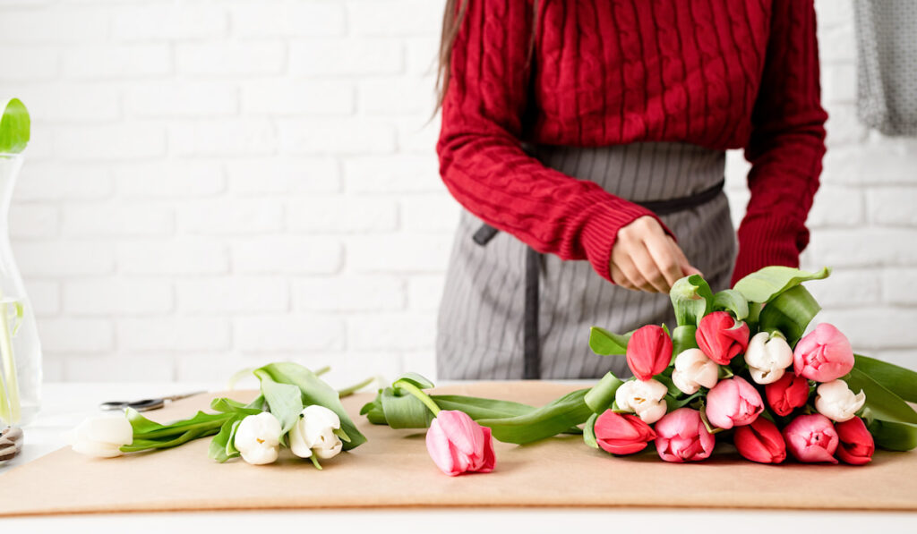 woman making a bouquet of fresh colorful tulips 
