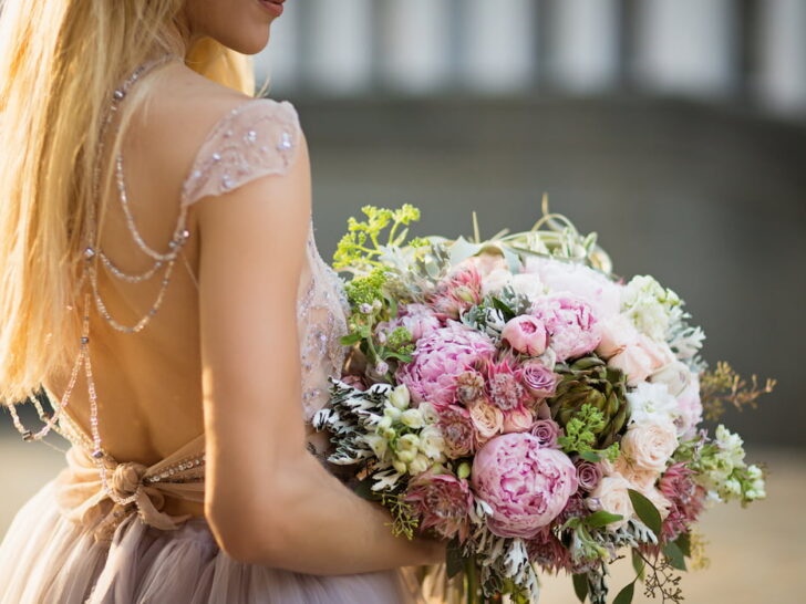 woman wearing grey wedding dress holding a wedding bouquet