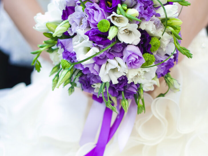 bride holding a beautiful purple bouquet