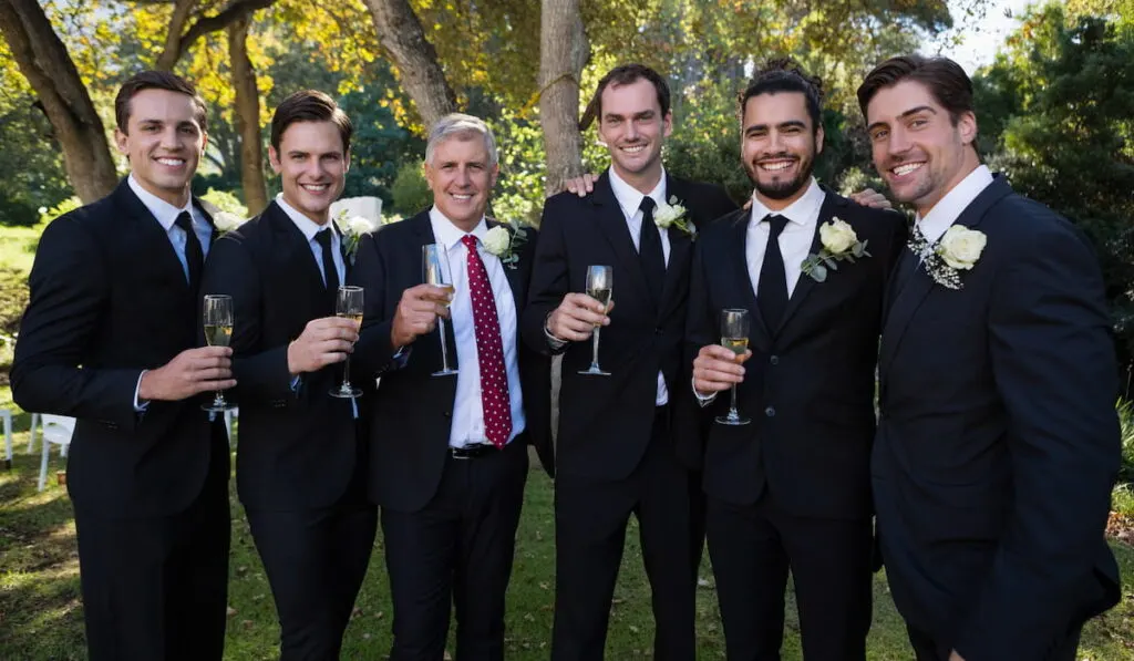 groom and groom's men having champagne 